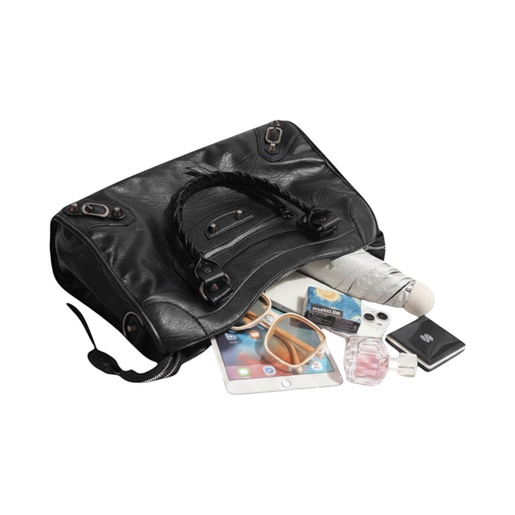 Univers Sac black PU leather saddle handbag with braided handle, zipper pockets, and metal hardware. Includes sunglasses, tablet, perfume, and umbrella.