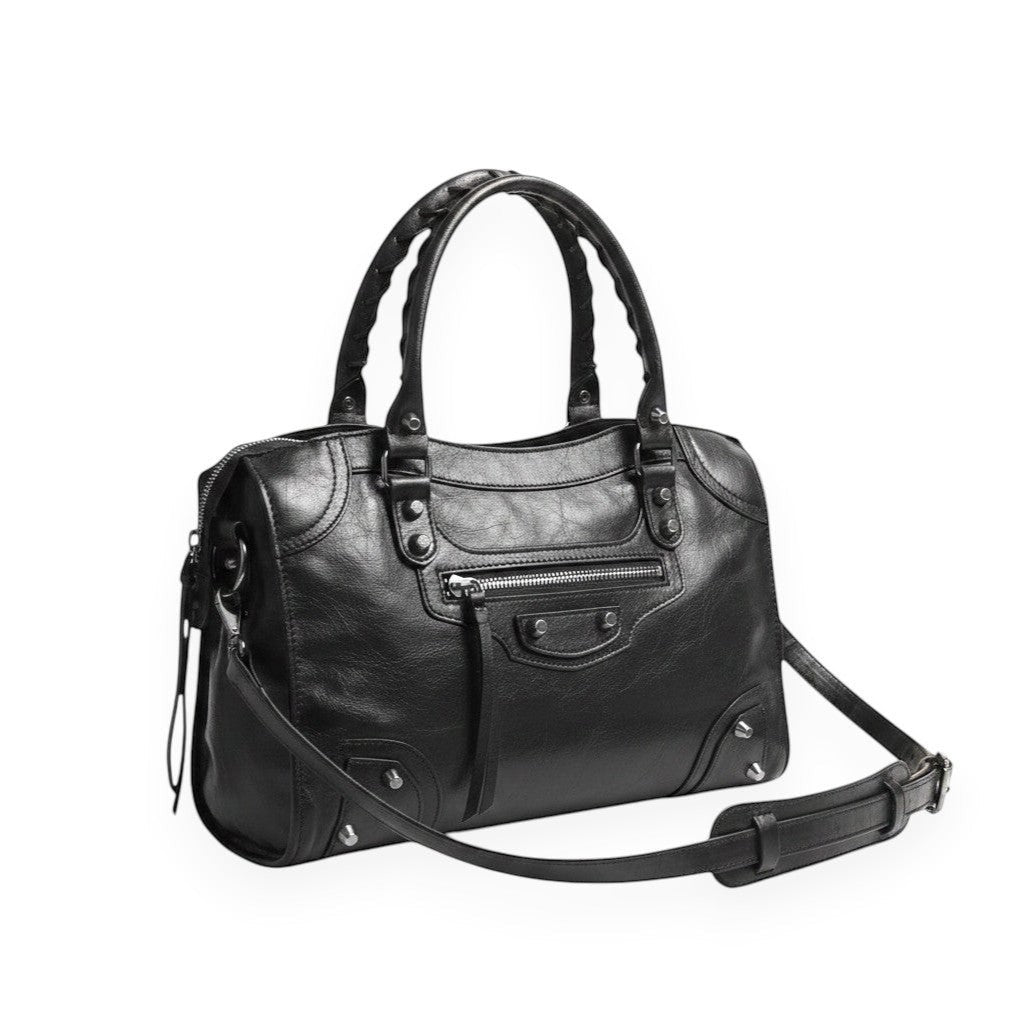 Univers Sac black leather saddle-shaped shoulder bag with single strap and studded handles.