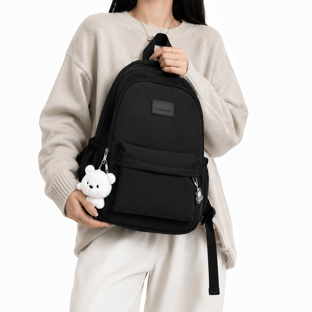 Sac à dos noir en coton imperméable Univers Sac avec porte-clés ours et breloque, idéal pour la ville et le quotidien.