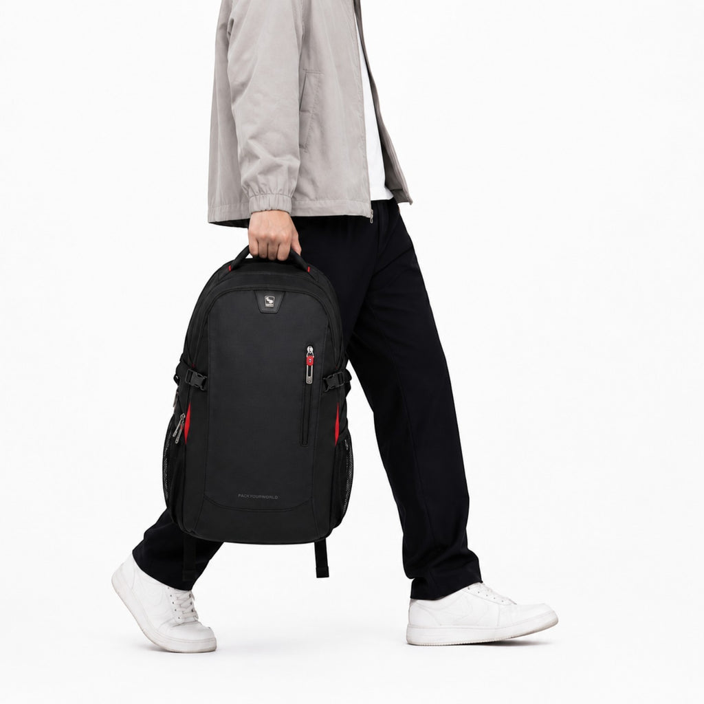 Un homme porte un sac à dos noir imperméable Univers Sac, idéal pour ordinateur portable, avec des détails rouges.