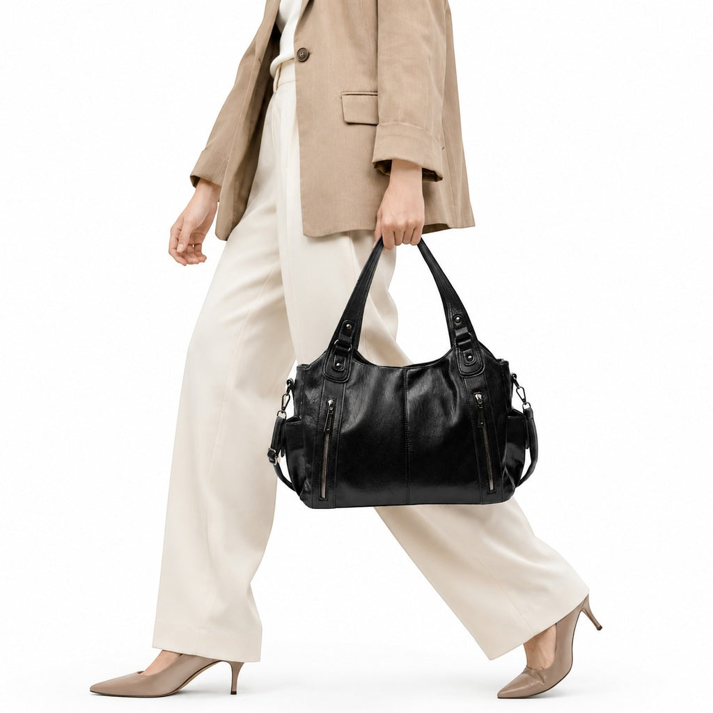 Sac bandoulière noir en cuir synthétique souple Univers Sac avec détails zippés et motif géométrique.