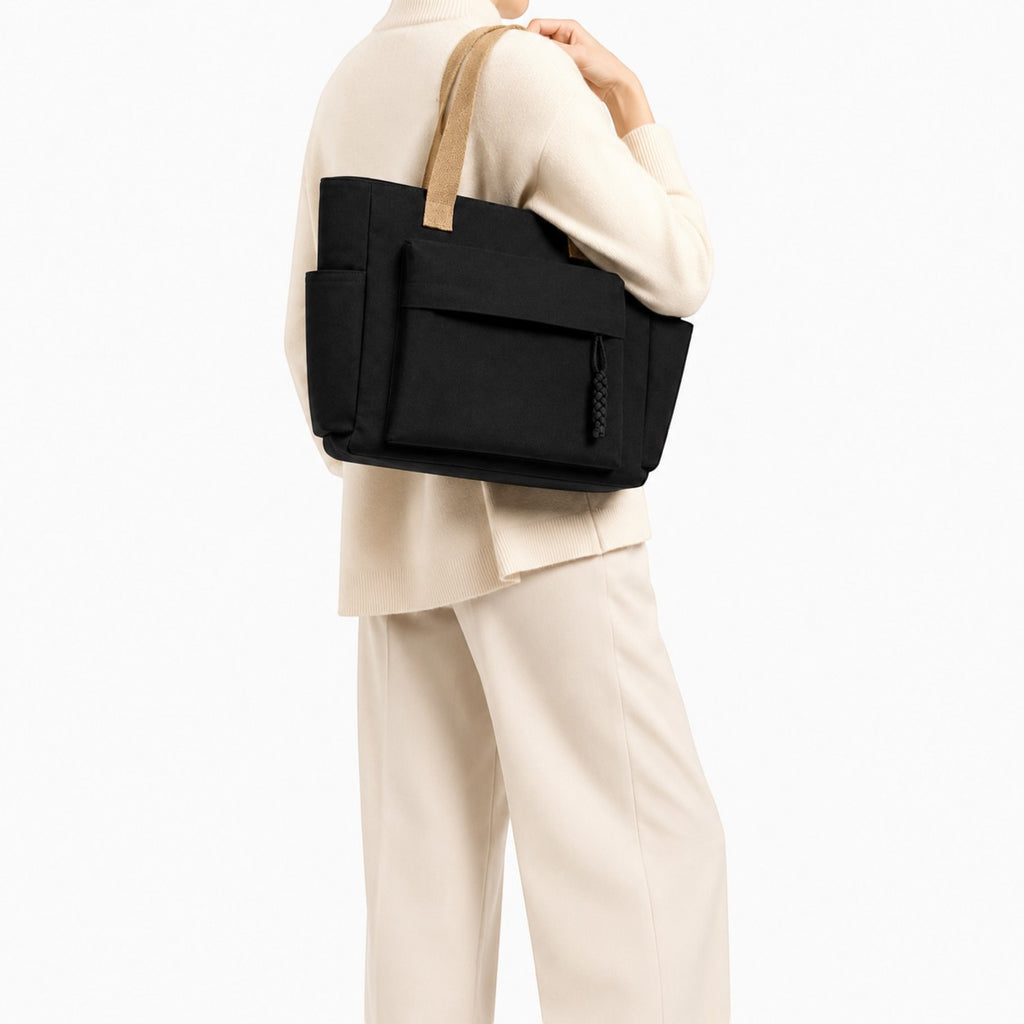 Sac bandoulière noir en toile Univers Sac avec poches extérieures et fermeture éclair, idéal pour un usage quotidien.