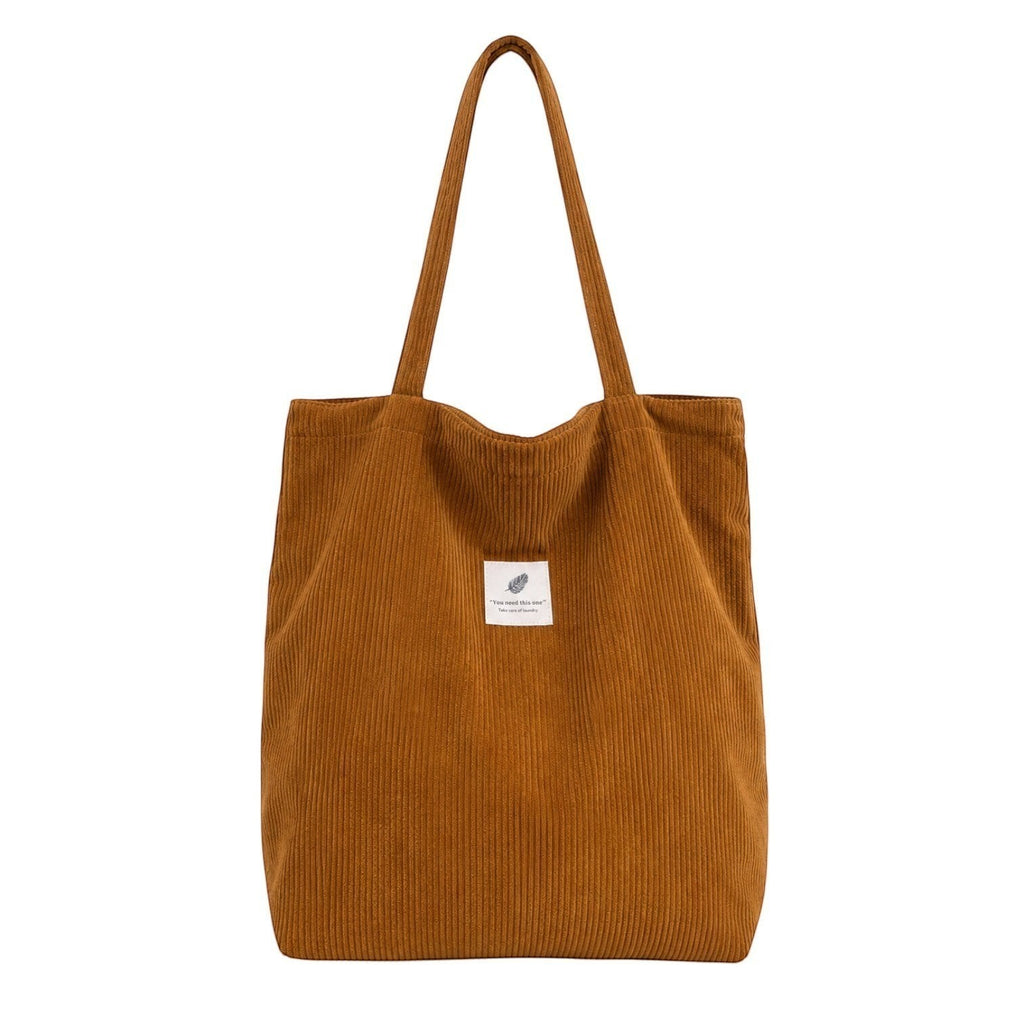 Sac fourre-tout marron en velours côtelé pour femme, avec deux anses et une poche intérieure.