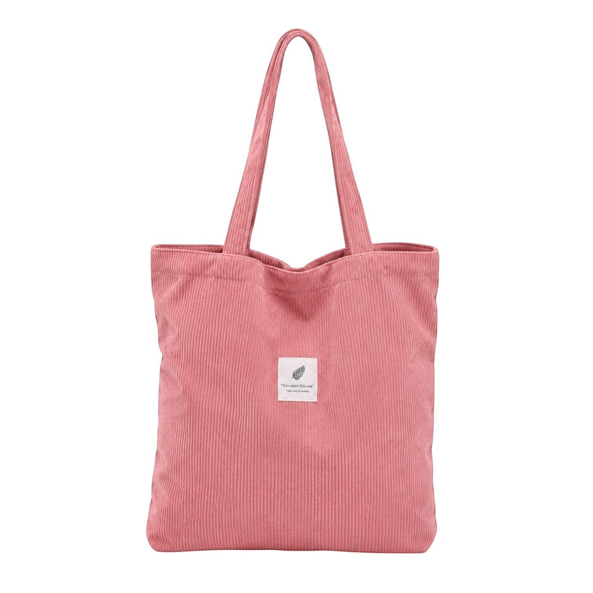 Sac fourre-tout rose en velours côtelé Univers Sac avec deux anses et une petite étiquette décorative.